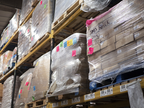 Office worker disposing of documents in a confidential waste bag